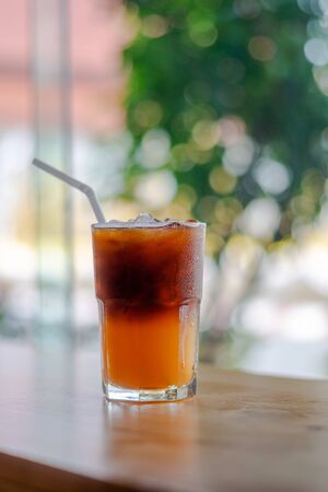 Ice coffee, americano coffee with orange in cafeの写真素材
