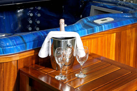 Champagne in ice bucket near hydromassage tubの写真素材