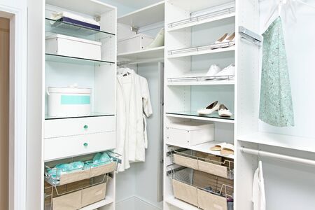 Detail of large walk in closet with modern wardrobe on hangersの写真素材