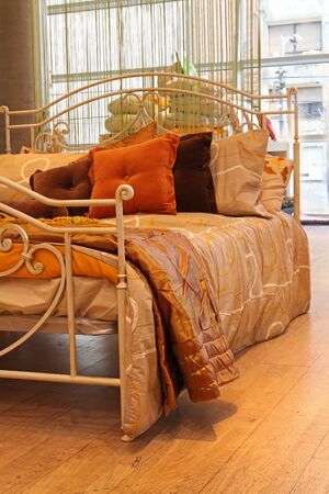 Metal vintage bed detail with decorative pillowsの写真素材