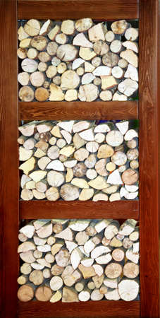 Large pile of firewood logs in big compartmentの写真素材