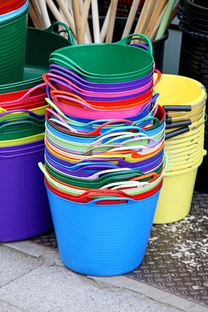 Bunch of colorful plastic bins sold on marketの写真素材