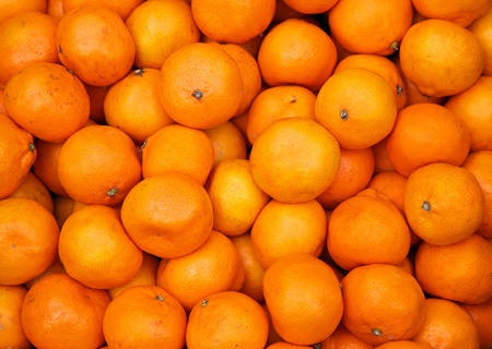 Bunch of fresh mandarin oranges on marketの写真素材