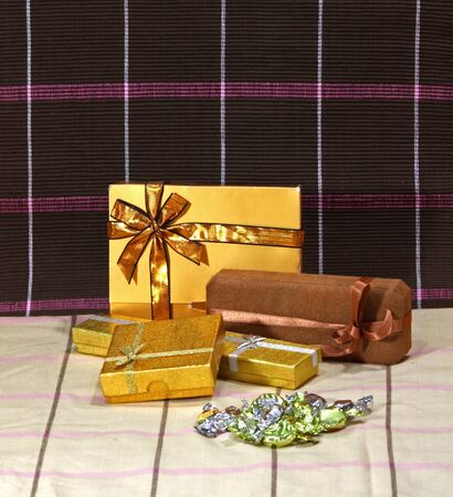 Present and chocolate boxes with gold ribbonの写真素材