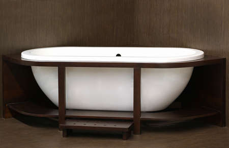 Retro white ceramic bathtub in wooden frameの写真素材