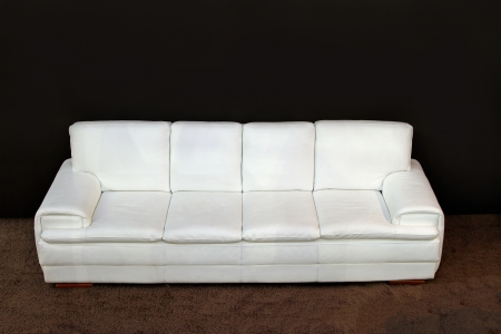 Modern white leather sofa on brown carpetの写真素材