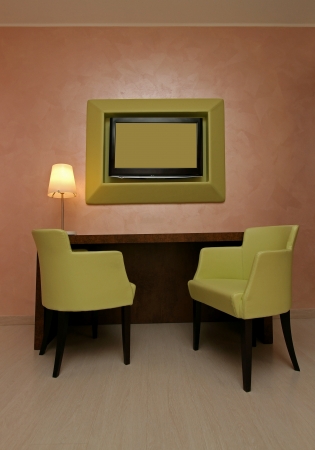 Green leather chairs and wall frame in modern interiorの写真素材
