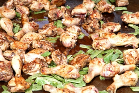 Pile of fried chicken legs with green vegetablesの写真素材