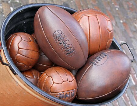 Bunch of leather sport balls in metal containerの写真素材