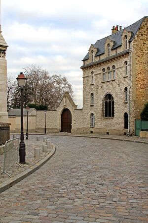 Old street with cobblestone road and retro lamp postの写真素材