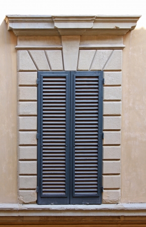 Old window with closed blinds from outsideの写真素材