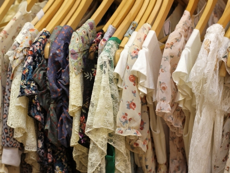 Floral design summer dresses on hangers on store rackの写真素材