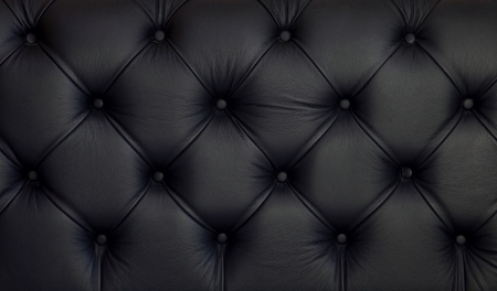 Detailed texture of creased black leather upholsteryの写真素材