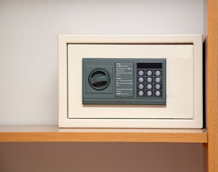 Small hotel safe inside wooden cabinet closed
