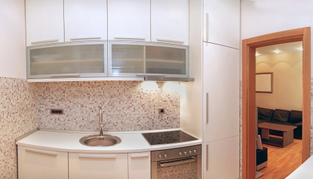 Small modern kitchen interior with beige tilesの写真素材