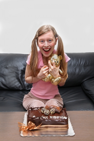 Teenage girl with birthday cake and teddy bearの写真素材