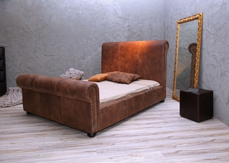 Vintage bedroom interior with leather bed and mirrorの写真素材