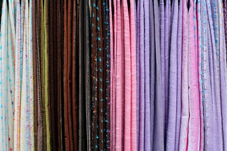Closeup of colorful pashmina scarves on market の写真素材