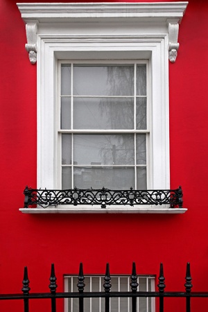 Vintage window on house with red facadeの写真素材