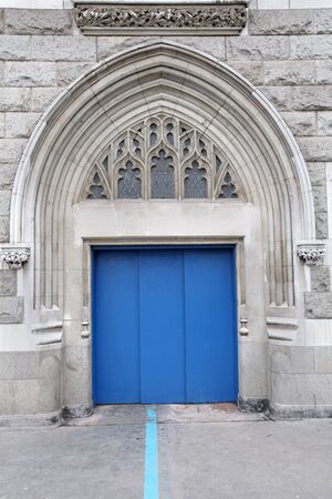 Blue entrance door on old stone facadeの写真素材