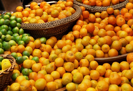 Assortment of citrus fruit displayed on marketの写真素材