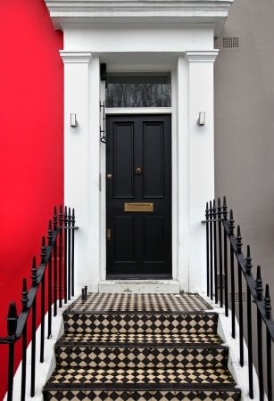Black entrance door on traditional London houseの写真素材