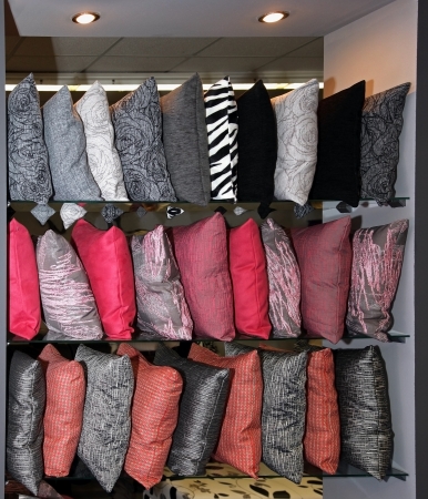 Decorative pillows with colorful patterns on store shelfの写真素材