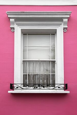 Retro window on house with pink facadeの写真素材