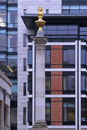 Old architecture pillar in London with gold fire on topの写真素材