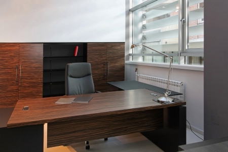 Wooden desk inside modern office interior with leather chairの写真素材
