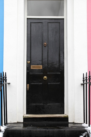 Black entrance door on retro residential houseの写真素材