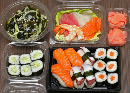 Takeaway Japanese food assortment on wooden tableの写真素材