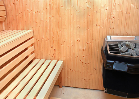 Small sauna interior with wooden bench inside houseの写真素材