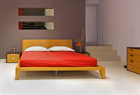 Modern bedroom interior with wooden double bedの写真素材