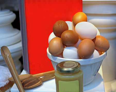 Raw eggs in kitchen with other ingredients for cake bakingの写真素材