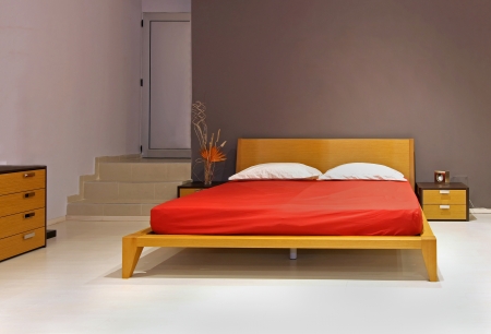 Modern bedroom interior with wooden double bedの写真素材