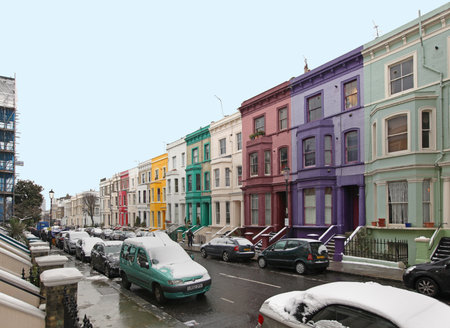 Street with colurful houses and cars under snow during winter in London, United Kingdom - January 19, 2013のeditorial素材