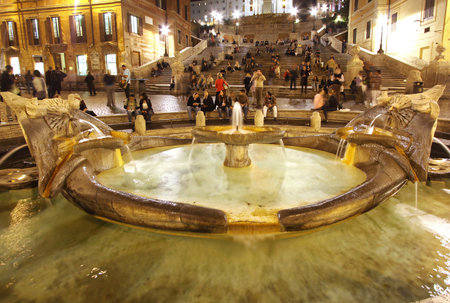 ROME, ITALY - OCTOBER 26  Fontana della Barcaccia on bottom of Spanish steps in Rome, Italy, October 26, 2009; Famous Italian landmark Piazza di Spagna during night in Rome with many tourist observing the attractionのeditorial素材