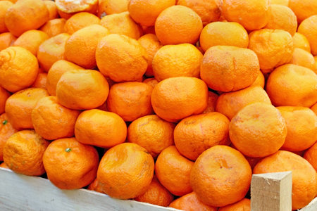 Big pile of fresh organic manadarine oranges sold on marketの写真素材