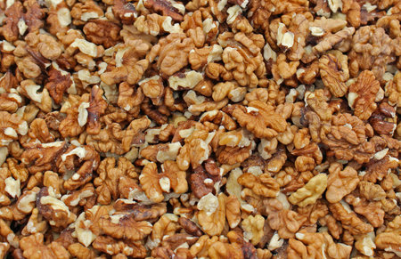 Big pile of raw walnuts out of shellの写真素材