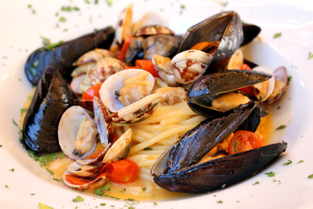 Fresh seafood pasta with shells and tomatoの写真素材