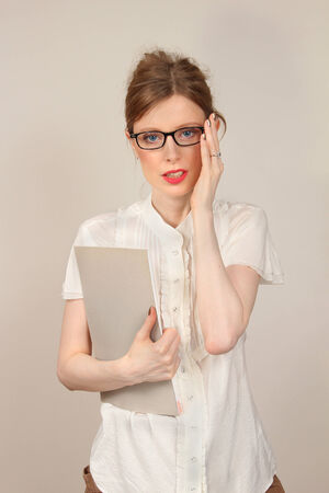 Young pretty woman on beginning of career in business with file in her handの写真素材