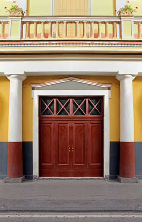 Large wooden entrance door on old buildingの写真素材
