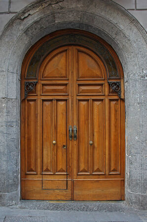 Old antique stone building entrance with wooden door の写真素材