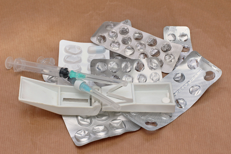 Pile of used medication blisters and syringesの写真素材