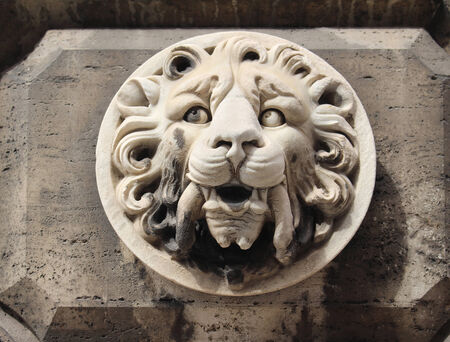 Stone sculpture lions head on ancient Roman buildingの写真素材