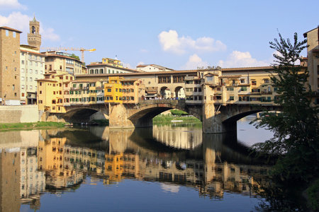 FLORENCE, ITALY - Sepptember 28; Famous landmark Ponte Vecchio with tourists walking down the bridge in Florence, Italy - September 28, 2009; Antique bridge in Florence over Arno river with old housesのeditorial素材