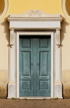 Old closed dark green wooden door exteriorの写真素材