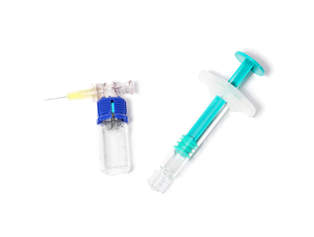 Medical syringe with glass container and needle filled with medicineの写真素材