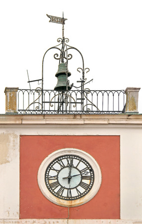 Old tower clock with Roman numerals and bells on topの写真素材